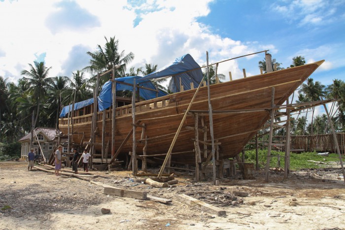 Stuart's 30 meter long boat, with Stuart and some workers in the bottom left