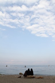 Girls watch while their men jet ski
